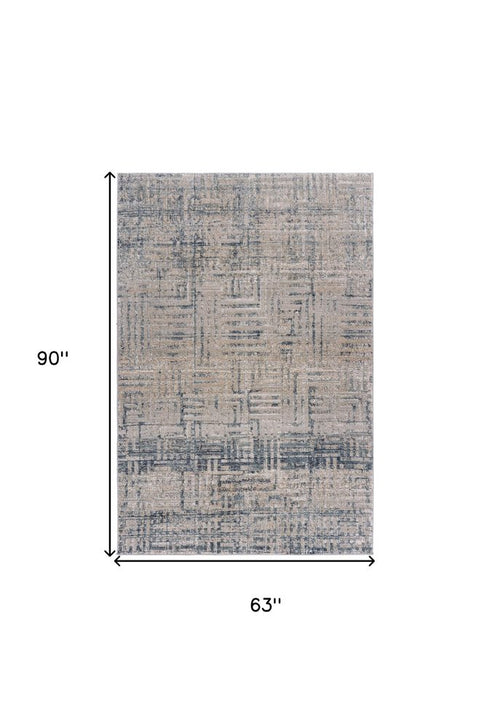 8' X 11' Cream Blue And Ivory Geometric Distressed Stain Resistant Area Rug