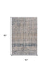 8' X 11' Cream Blue And Ivory Geometric Distressed Stain Resistant Area Rug
