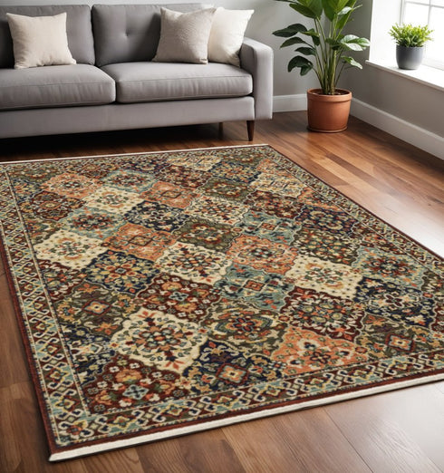 8' X 11' Red Rust Navy Light Blue Brown Orange Ivory And Gold Oriental Power Loom Stain Resistant Area Rug With Fringe