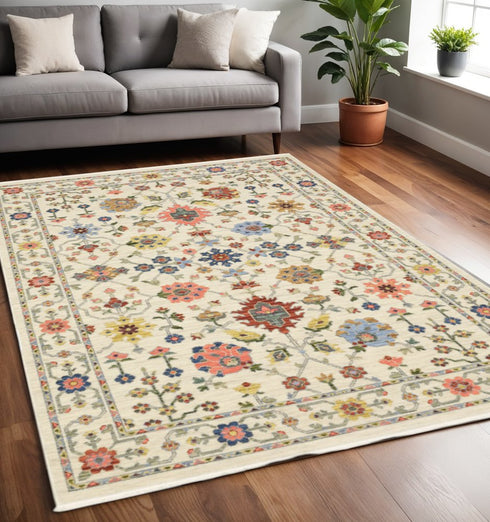 8' X 11' Ivory Salmon Pink Gold Blues Grey Rust And Green Oriental Power Loom Stain Resistant Area Rug With Fringe