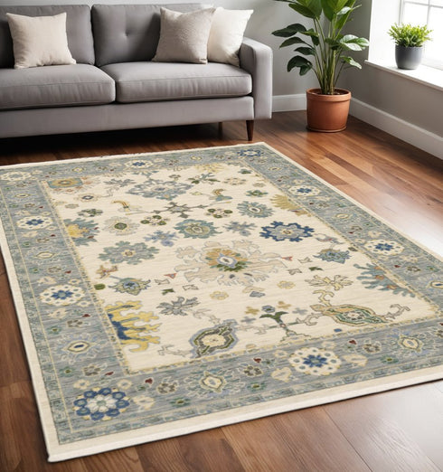 8' X 11' Ivory Blue Grey Teal Gold Green And Rust Oriental Power Loom Stain Resistant Area Rug With Fringe
