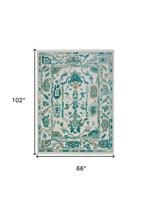8' X 12' Green and Ivory Wool Floral Hand Knotted Area Rug With Fringe