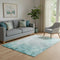 5' X 8' Teal And Ivory Abstract Washable Area Rug With UV Protection