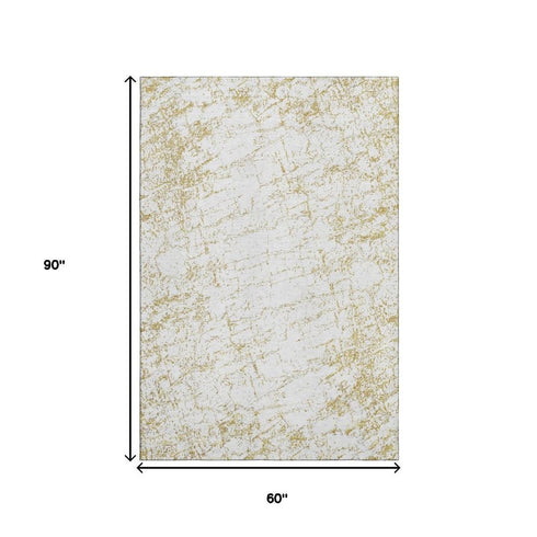5' X 8' Gold And Ivory Abstract Washable Area Rug With UV Protection