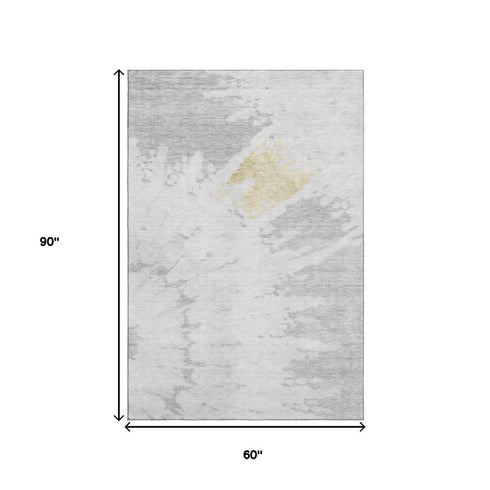 5' X 8' Silver Gold And Ivory Abstract Washable Area Rug With UV Protection