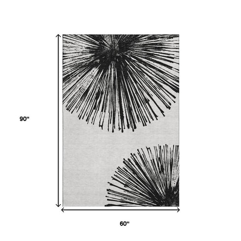 5' X 8' Black And Ivory Abstract Washable Area Rug With UV Protection
