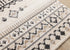 5' X 8' Cream And Black Tribal Area Rug