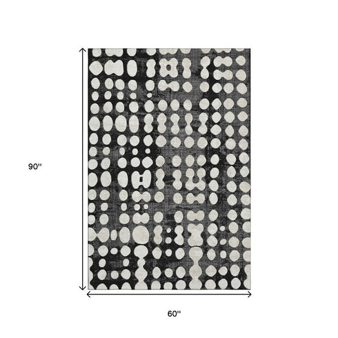 5' X 8' Black And Ivory Polka Dot Washable Area Rug With UV Protection