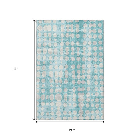 5' X 8' Teal And Ivory Polka Dot Washable Area Rug With UV Protection