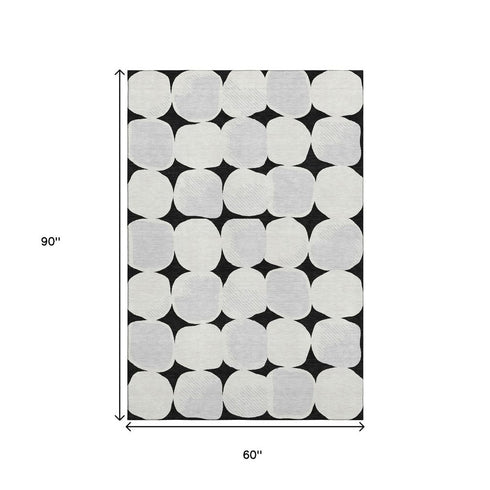 5' X 8' Black And Ivory Abstract Geometric Washable Area Rug With UV Protection