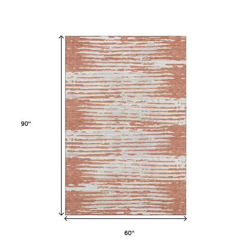 5' X 8' Coral And Ivory Striped Washable Area Rug With UV Protection