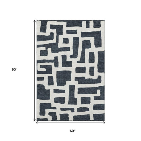 5' X 8' Black And Ivory Abstract Geometric Washable Area Rug With UV Protection