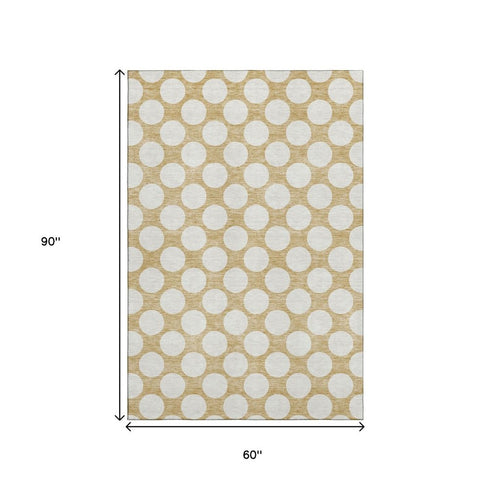 5' X 8' Gold And Ivory Polka Dot Washable Area Rug With UV Protection