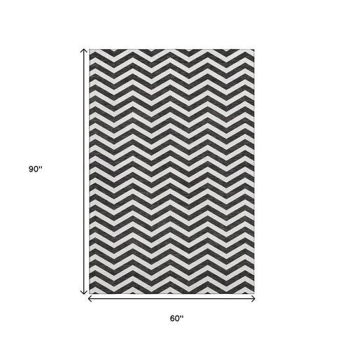 5' X 8' Black And Ivory Chevron Washable Area Rug With UV Protection