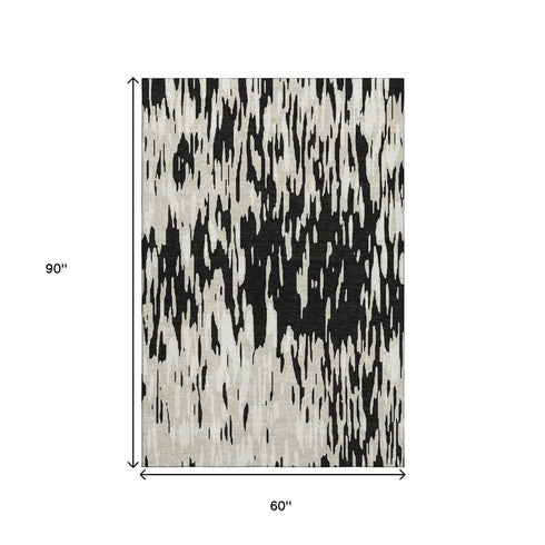 5' X 8' Black And Ivory Abstract Washable Area Rug With UV Protection