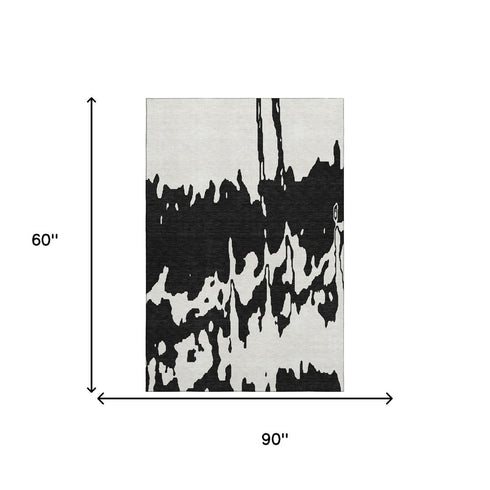 5' X 8' Black And Ivory Abstract Washable Area Rug With UV Protection