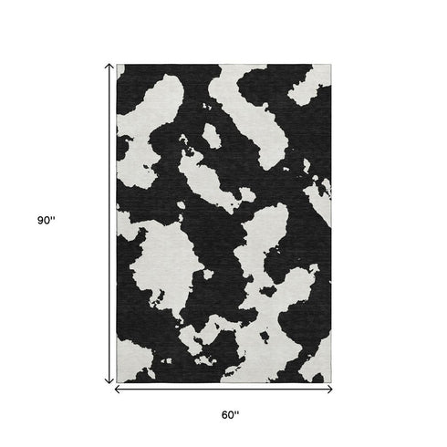 5' X 8' Black And Ivory Abstract Washable Area Rug With UV Protection
