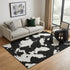5' X 8' Black And Ivory Abstract Washable Area Rug With UV Protection