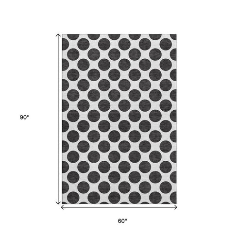 5' X 8' Black And Ivory Polka Dot Washable Area Rug With UV Protection