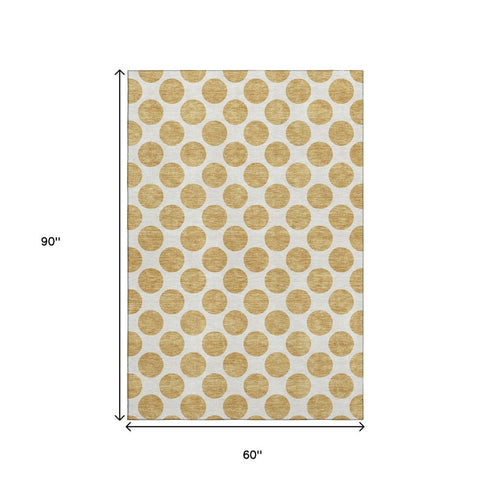 5' X 8' Gold And Ivory Polka Dot Washable Area Rug With UV Protection