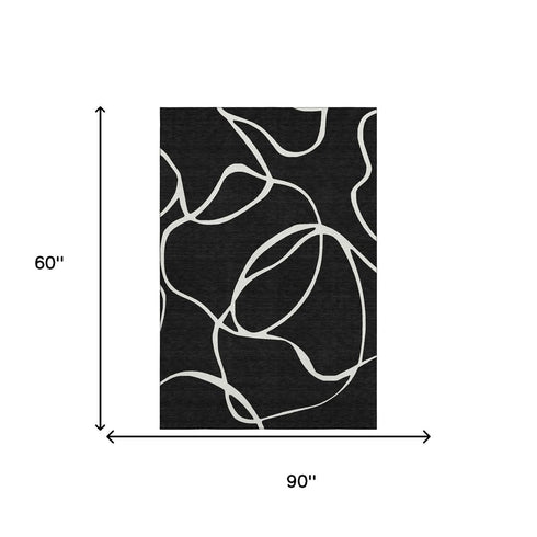 5' X 8' Black And Ivory Abstract Washable Area Rug With UV Protection