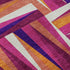 5' X 8' Burgundy Purple And Orange Geometric Washable Area Rug With UV Protection