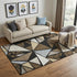 5' X 8' Brown Black And Ivory Geometric Washable Area Rug With UV Protection