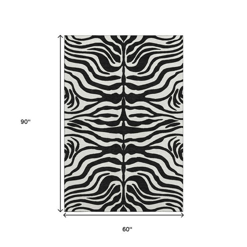 5' X 8' Black And Ivory Animal Print Washable Area Rug With UV Protection