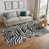 5' X 8' Black And Ivory Animal Print Washable Area Rug With UV Protection