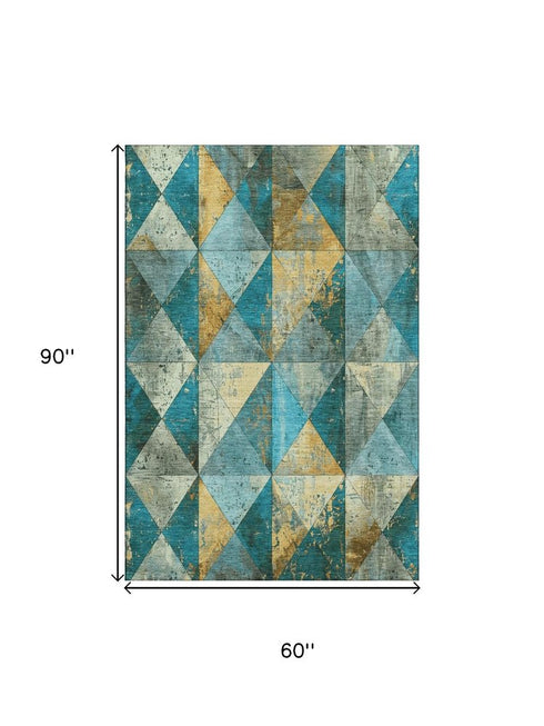 5' X 8' Teal Gold And Ivory Geometric Washable Area Rug With UV Protection