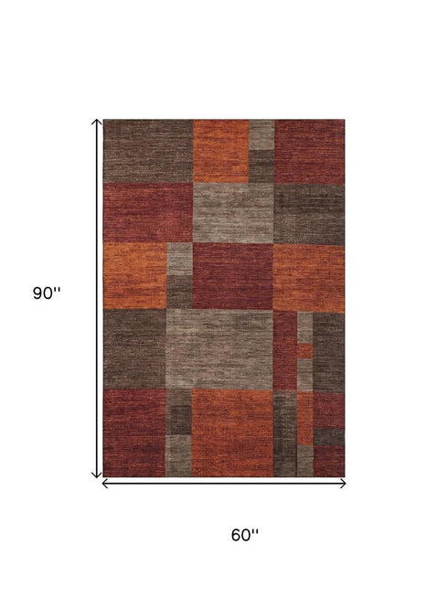 5' X 8' Chocolate Orange And Rust Geometric Washable Area Rug With UV Protection
