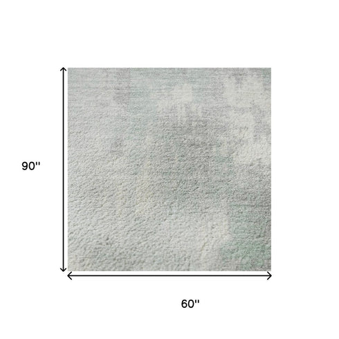 5' X 8' Mint Green And Ivory Abstract Washable Area Rug With UV Protection