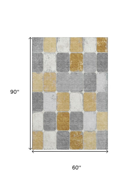 5' X 8' Gold Gray And Ivory Geometric Washable Area Rug With UV Protection