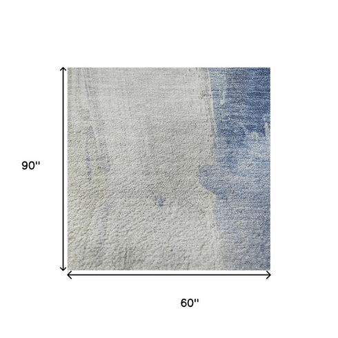 5' X 8' Denim Blue Gray And Ivory Abstract Washable Area Rug With UV Protection