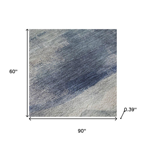 5' X 8' Blue And Ivory Abstract Washable Area Rug With UV Protection