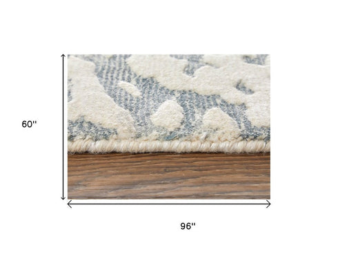 5' X 8' Blue And Ivory Abstract Hand Woven Area Rug