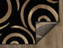 Black, Beige, and Gold Circle Swirls Abstract Area Rug