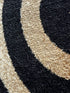 Black, Beige, and Gold Circle Swirls Abstract Area Rug